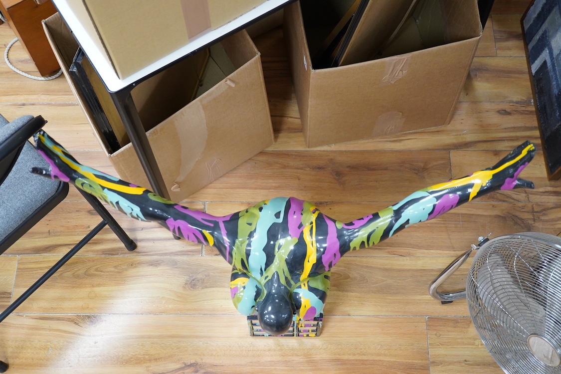 A large contemporary multicoloured composition sculpture of a diver, with mirrored base, 81cm high